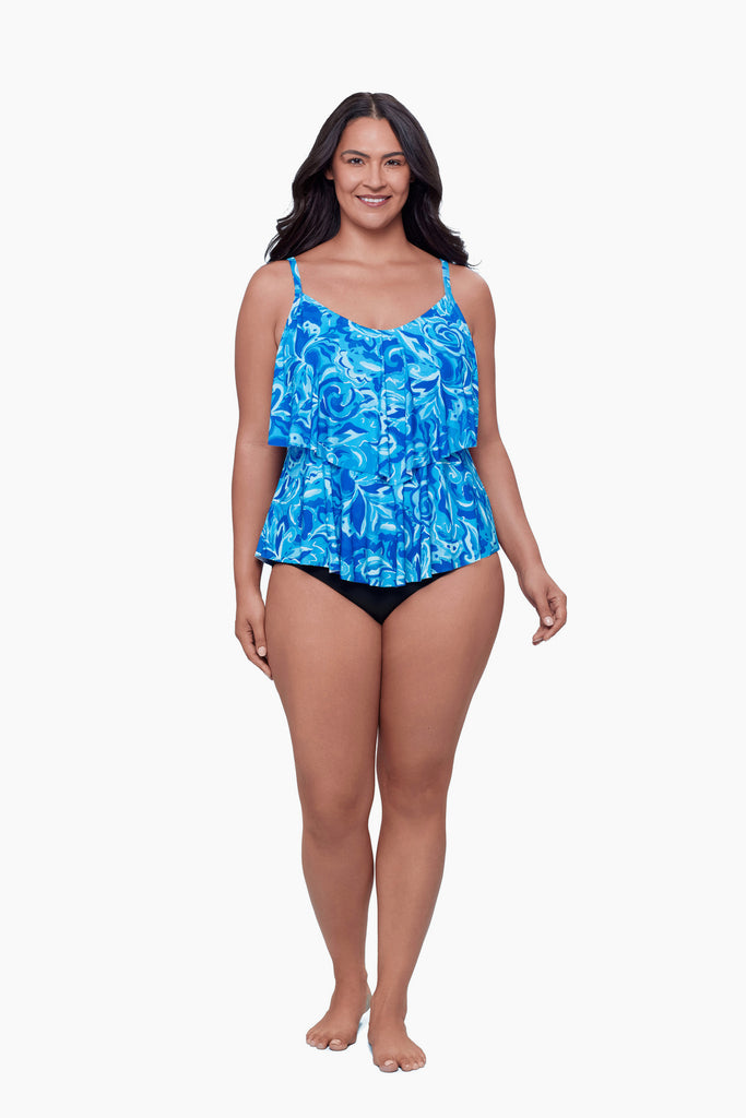 Woman wearing a tiered tankini top with an abstract blue print