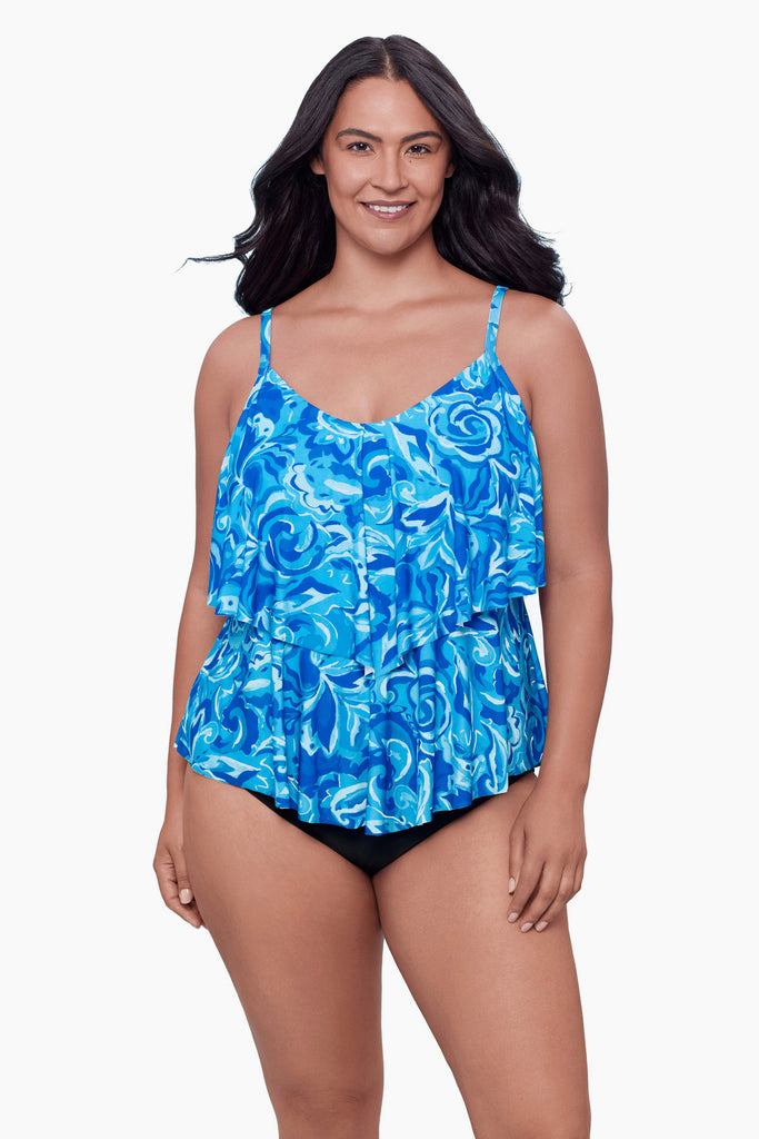 Woman wearing a tiered tankini top with an abstract blue print