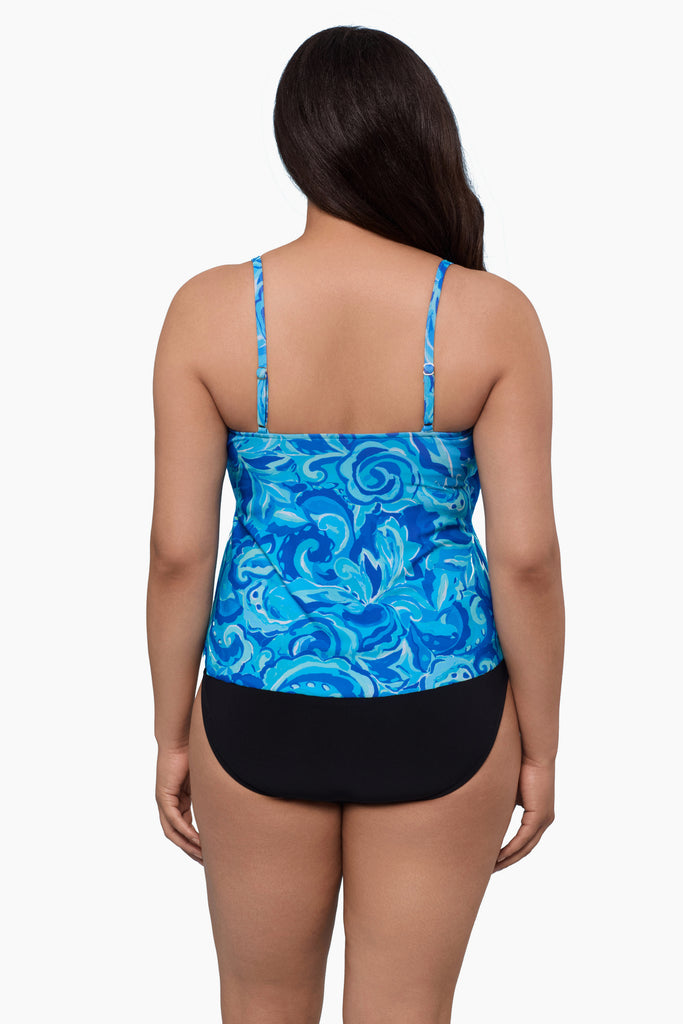Woman turned away wearing a tankini top with an abstract blue pattern