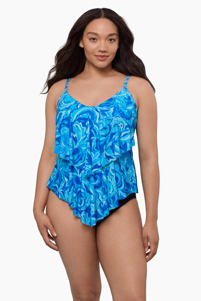 Woman wearing a tiered tankini top with an abstract blue pattern