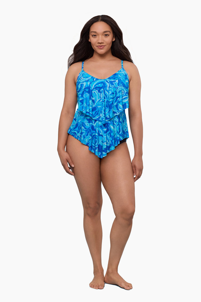 Woman wearing a tiered tankini top with an abstract blue pattern