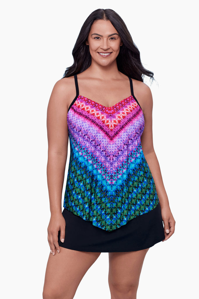 Woman wearing a tankini top with a multicolored geometric pattern