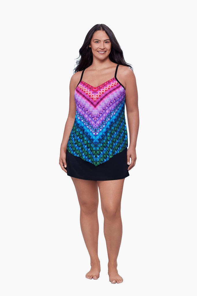 Woman wearing a tankini top with a multicolored geometric pattern