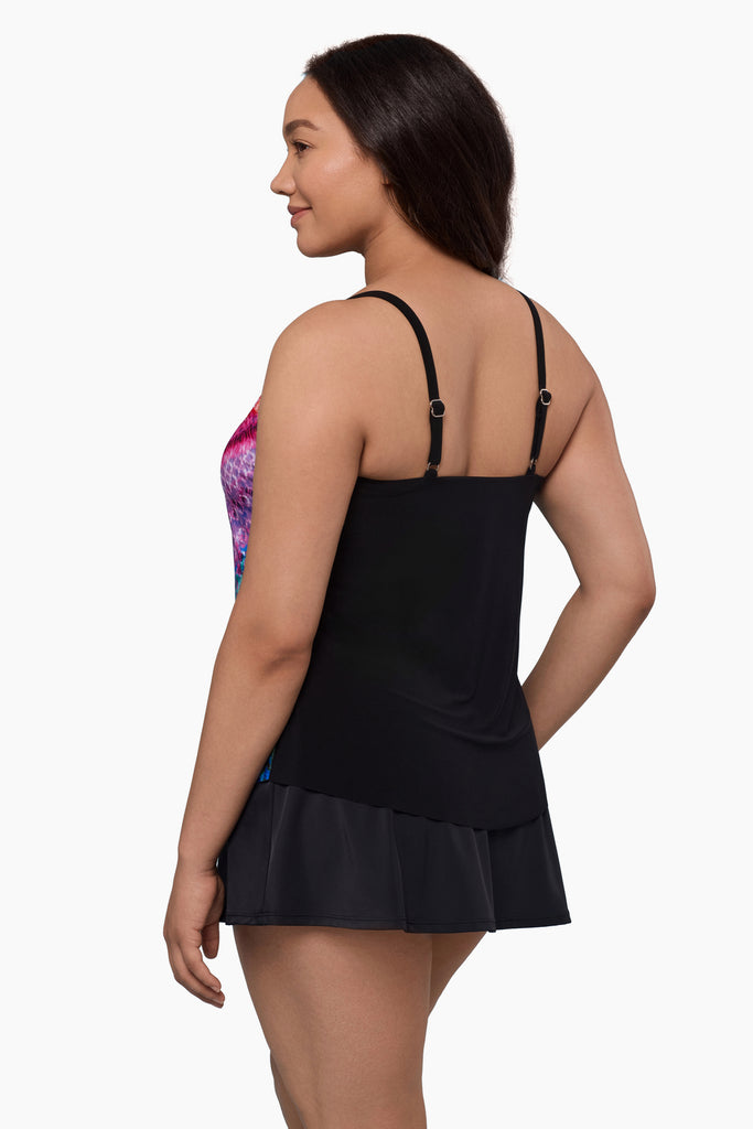 Woman turned left wearing a tankini top with a multicolored geometric print