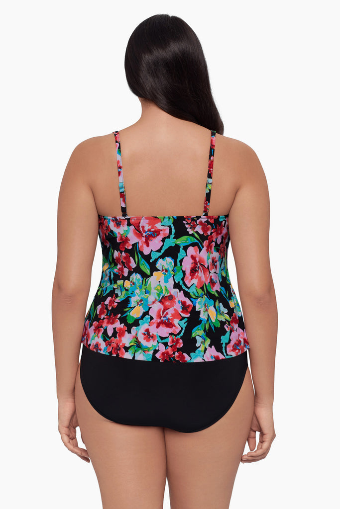 Woman turned away wearing a tiered tankini top with a floral print