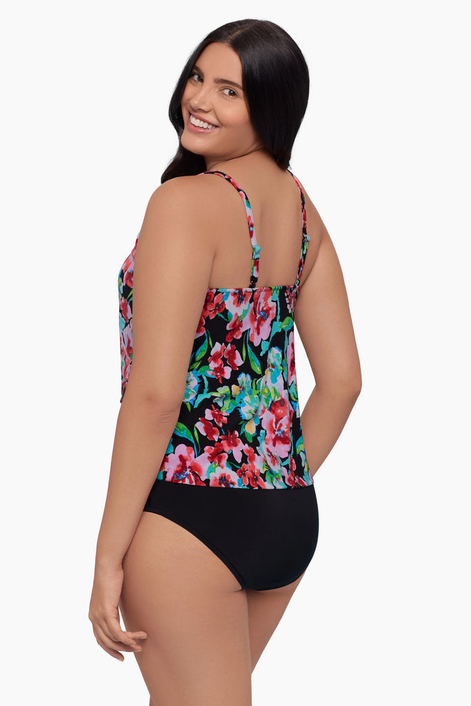 Woman turned left wearing a tiered tankini top with a floral print