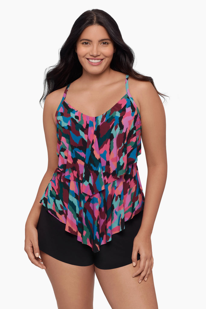 Woman wearing a tiered tankini top with a collage patchwork print