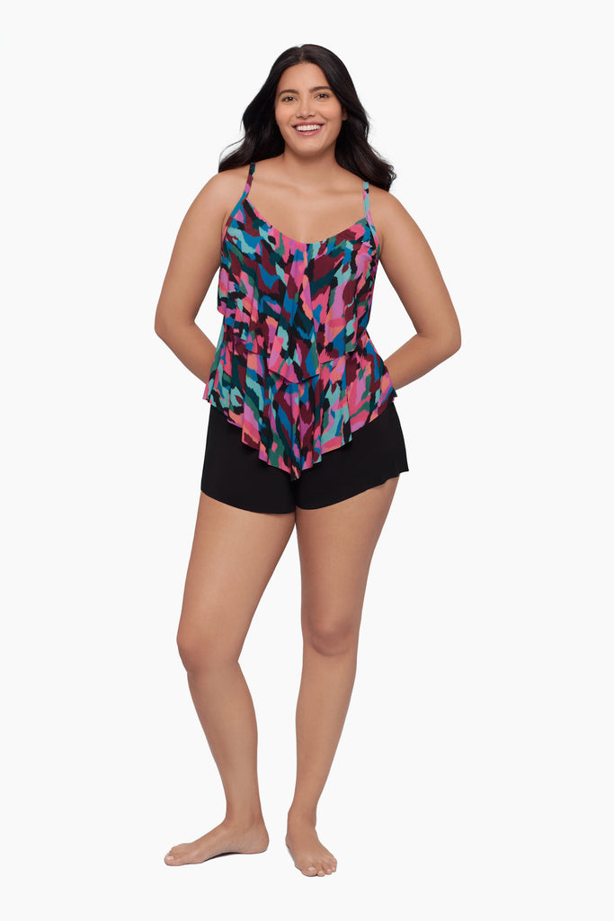 Woman wearing a tiered tankini top with a collage patchwork print