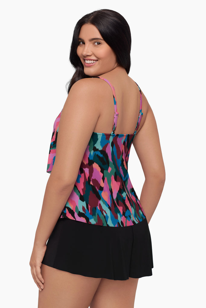 Woman turned left wearing a tiered tankini top with a collage patchwork print
