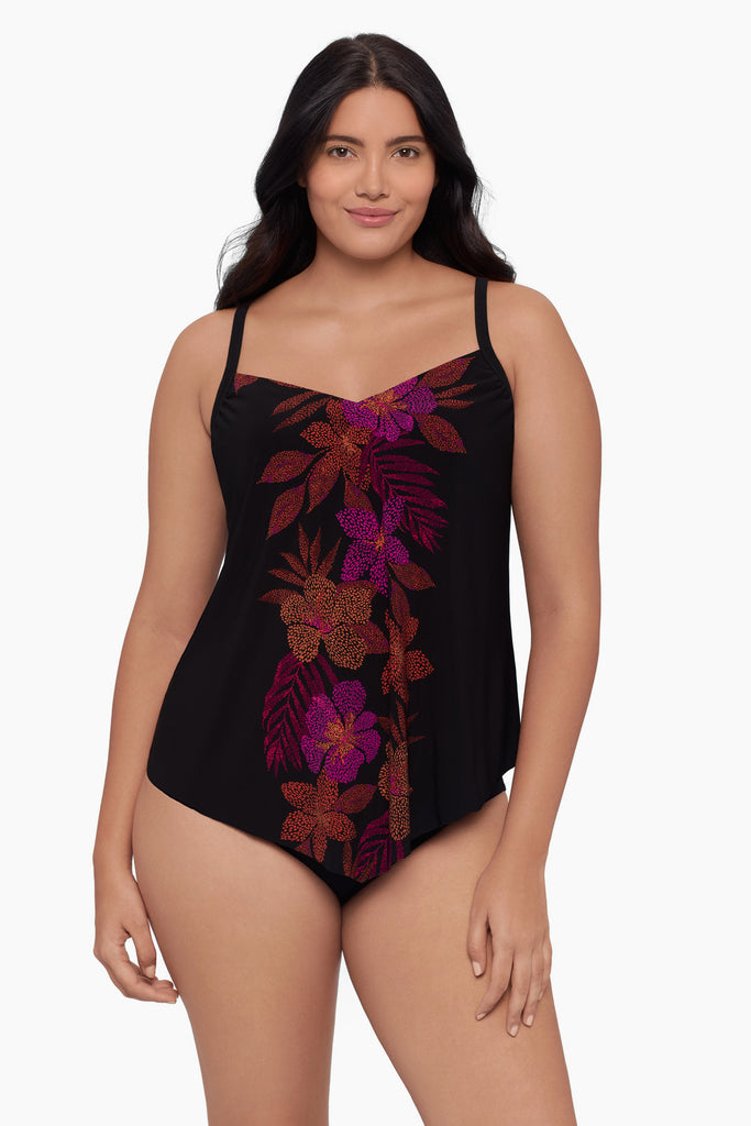 Woman wearing a tankini top with a faded floral print