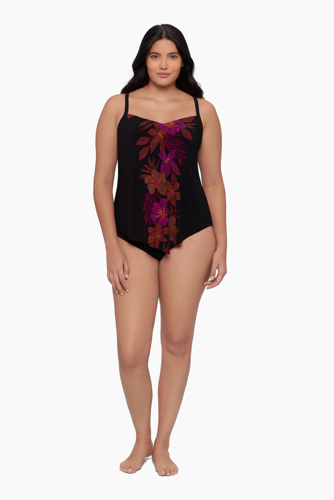 Woman wearing a tankini top with a faded floral print