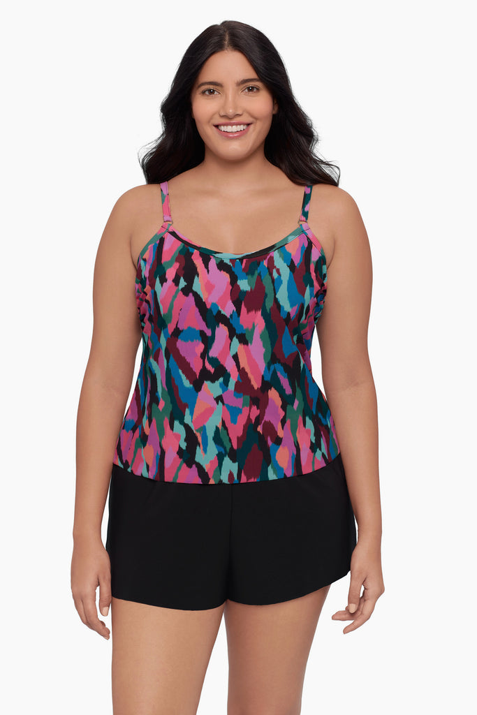 Woman wearing a swim romper with a collage patchwork print