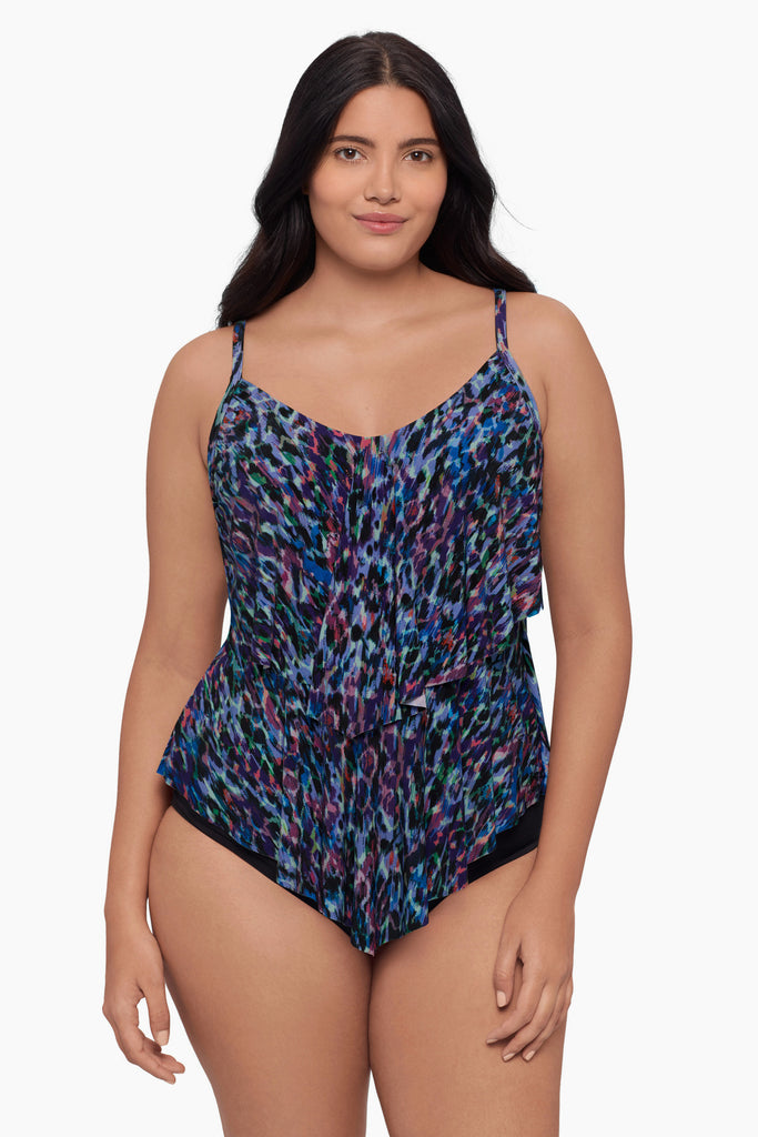 Woman wearing a blue abstract tankini top with ruffles