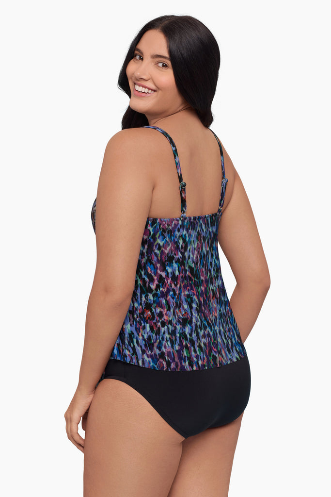 Woman turned left wearing a blue abstract tankini top with ruffles