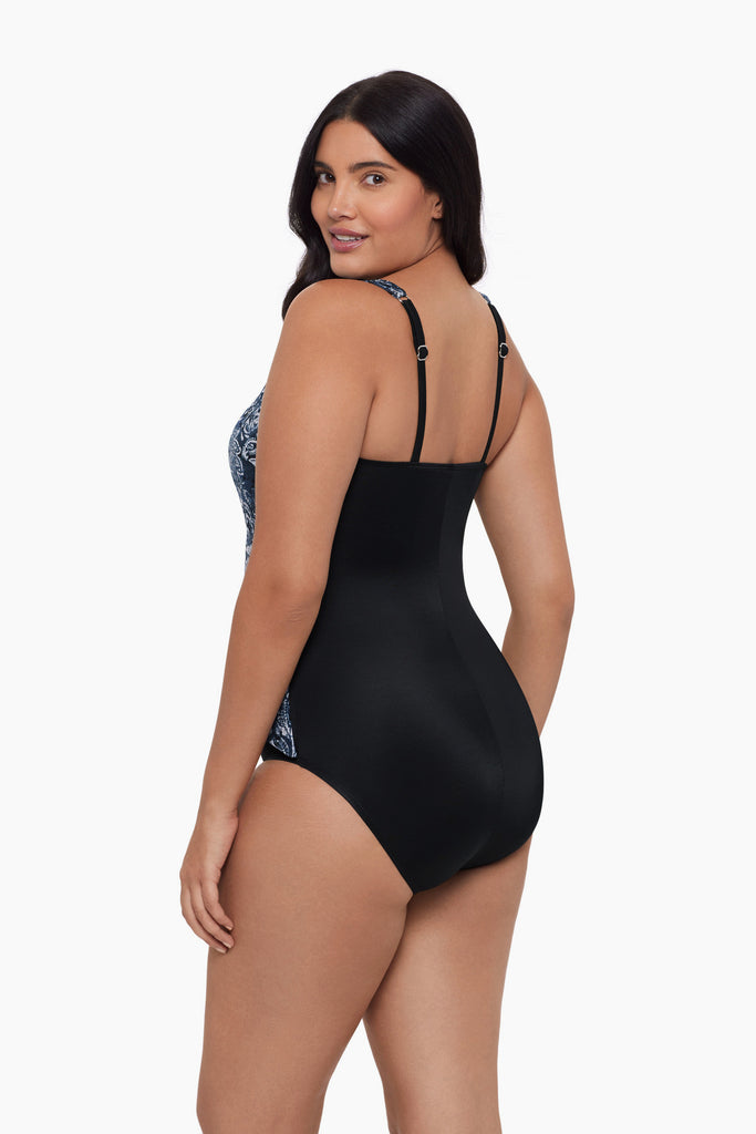 Woman turned left wearing one-piece swimsuit with a paisley-esque pattern 