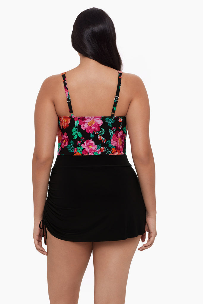 Woman turned away wearing a swim dress with a floral pattern