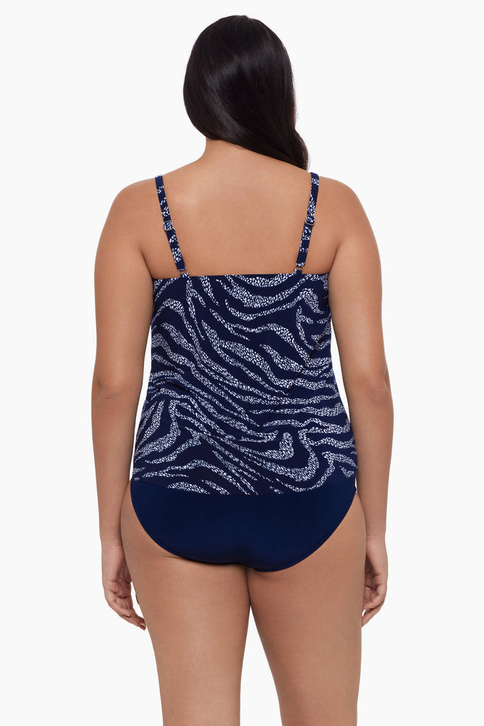 Woman turned away wearing a tankini top with a blue and white print