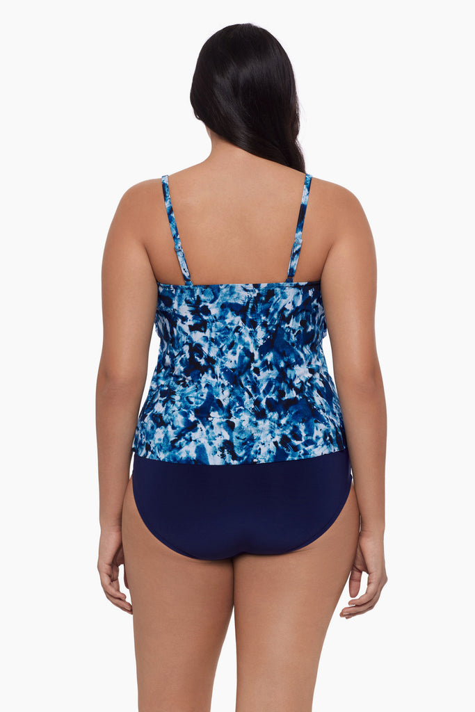 Woman turned away wearing a tankini top with a blue tie dye print