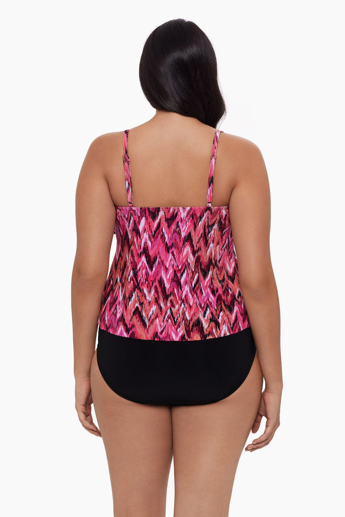 Woman turned away wearing a tankini top with an abstract pink pattern