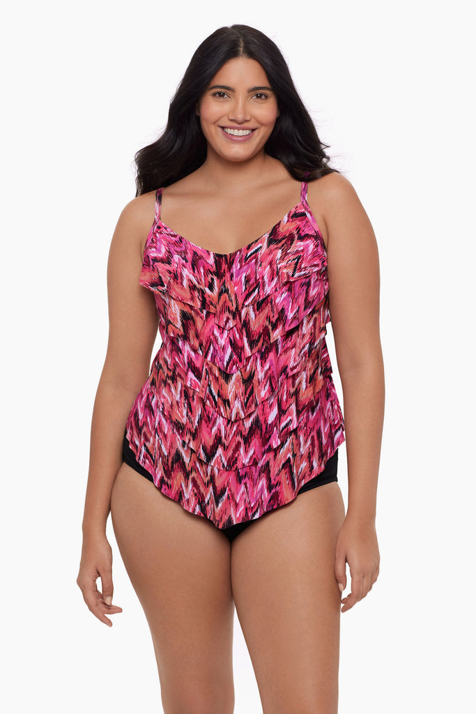 Woman wearing a tiered tankini top with an abstract pink pattern 