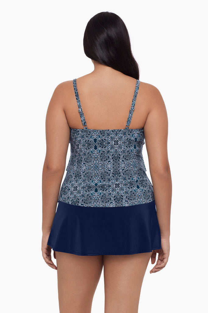 Woman turned away wearing a tankini top with a blue tile pattern