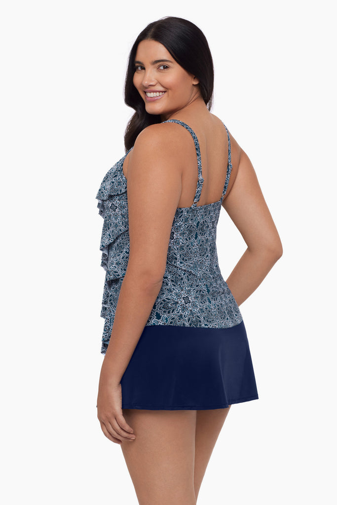 Woman turned left wearing a tiered tankini top with a blue tile pattern
