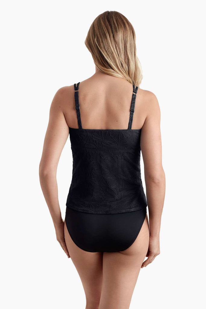 Woman facing away to show raised floral detail of tankini top