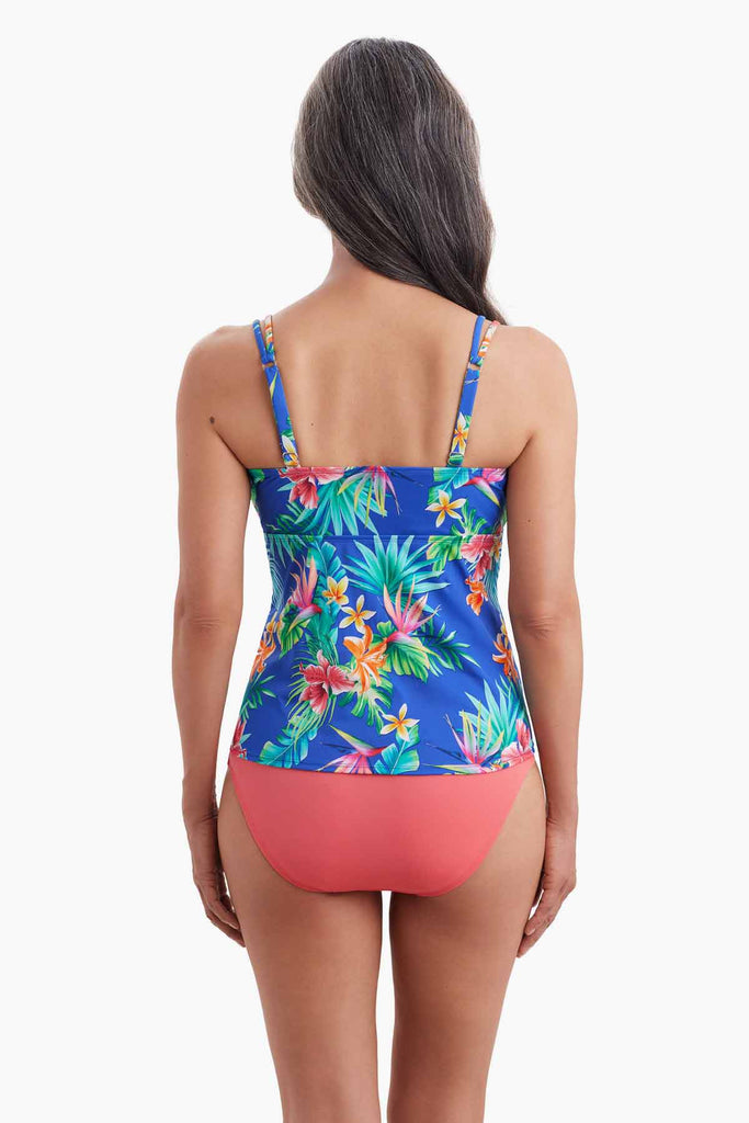 Woman turned away wearing a tankini top with multicolor floral print