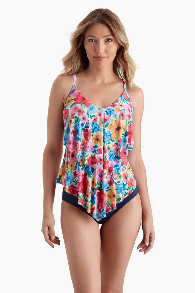 Woman wearing a flowy tankini top with multicolored floral print