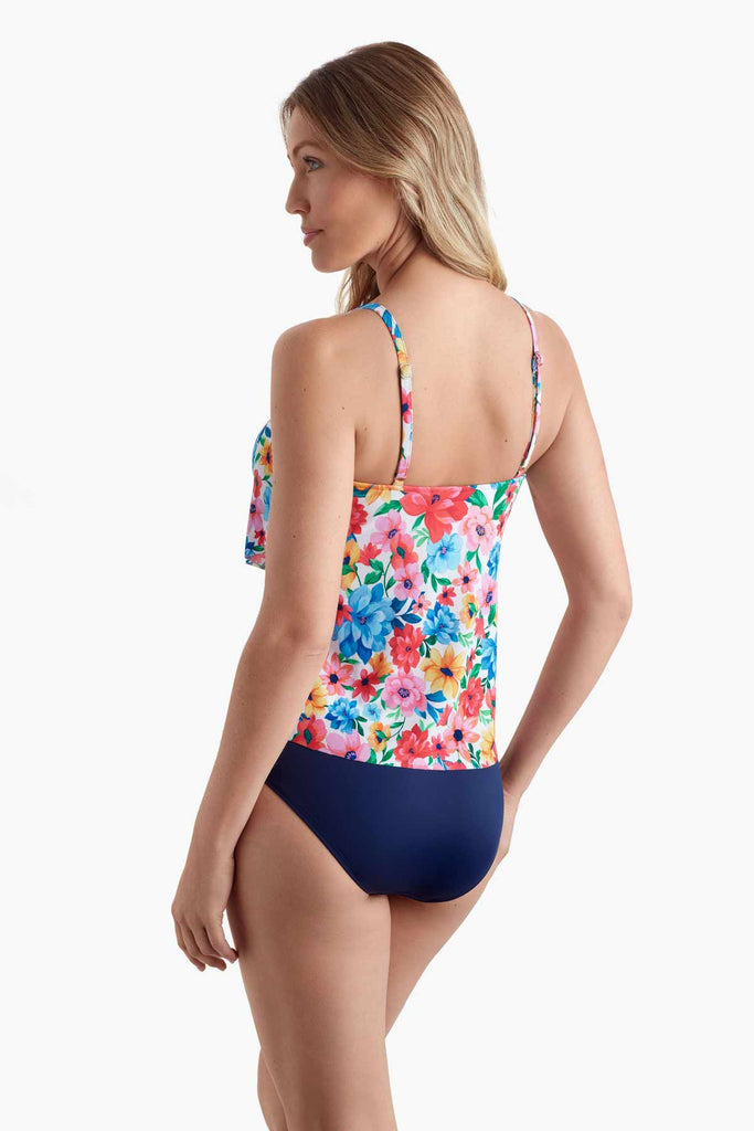 Woman turned left wearing a tankini top with multicolored floral print
