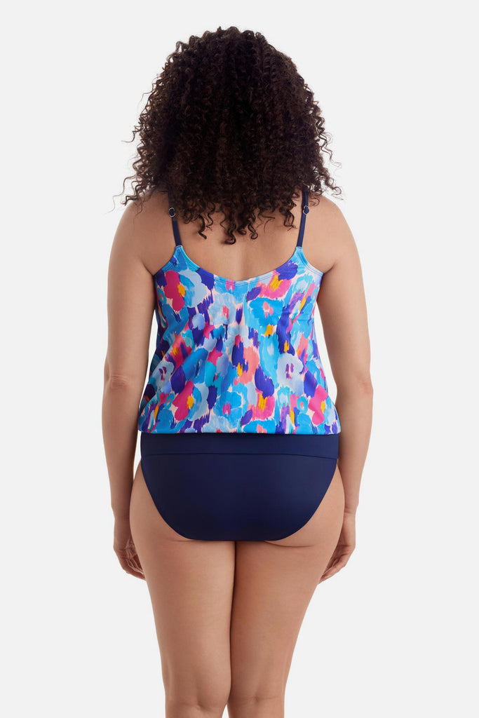Woman turned away wearing a multicolor abstract print blouson tankini top