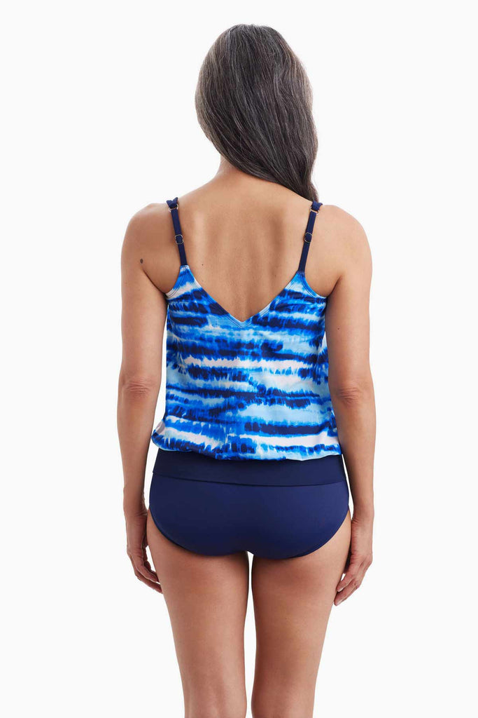 Woman turned away wearing a tankini top with a blue tie dye print