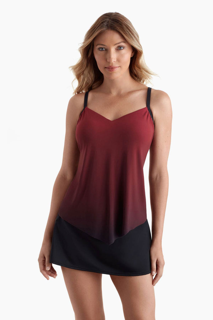 Woman wearing a tankini top that fades from red to black