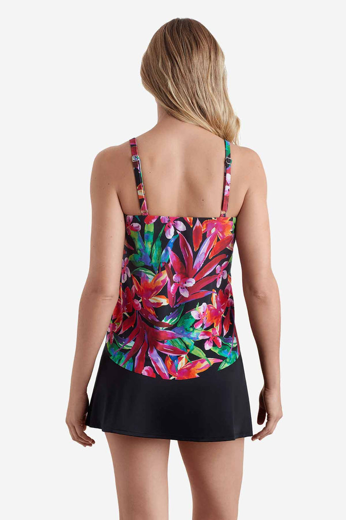 Woman faced away wearing a tankini top with a multicolored floral print