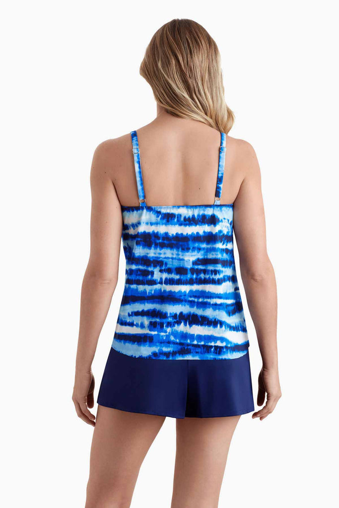 Woman turned away wearing a tankini top with a blue tie dye print