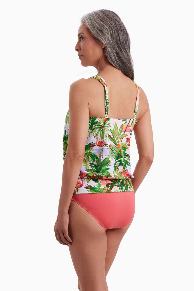 Woman faced left wearing a blouson tankini top with a tropical flamingo print