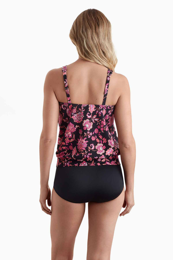 Woman faced away wearing a tankini top with a pink floral pattern