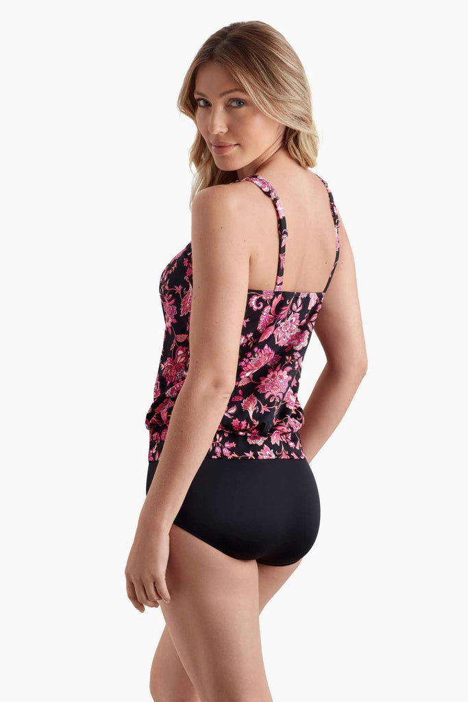 Woman faced left wearing a shirred neck tankini top with a pink floral pattern