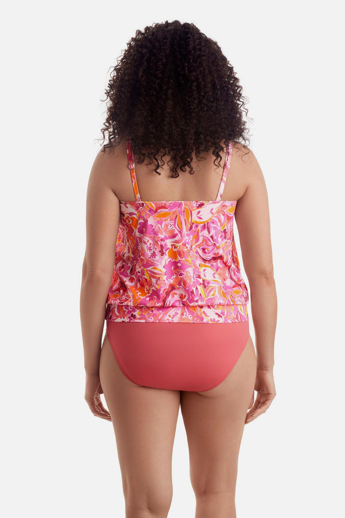 Woman turned away wearing a pink floral printed shirred neck blouson tankini top