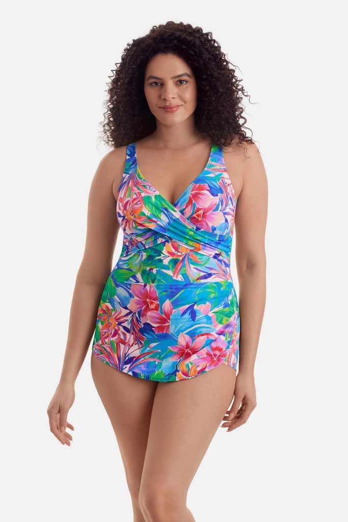 Woman wearing a multicolored floral print sarong one-piece swimsuit