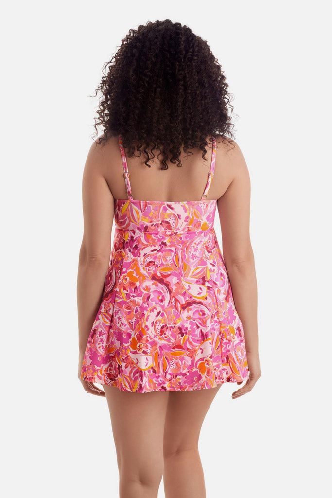 Woman turned away wearing a pink floral printed swim dress 