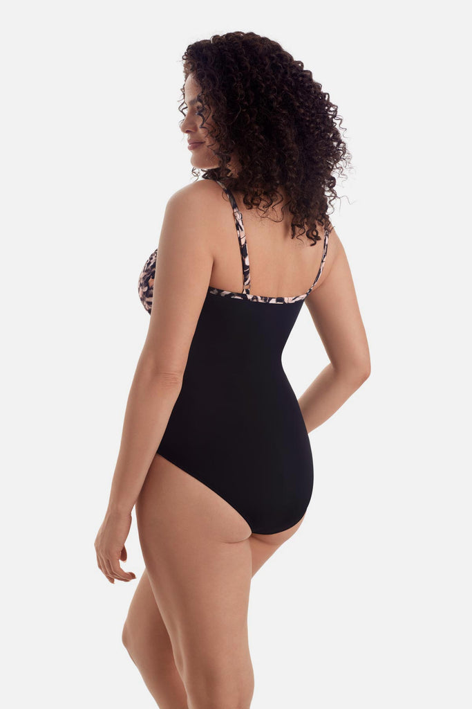 Woman turned left wearing a brown butterfly wing printed one-piece swimsuit 