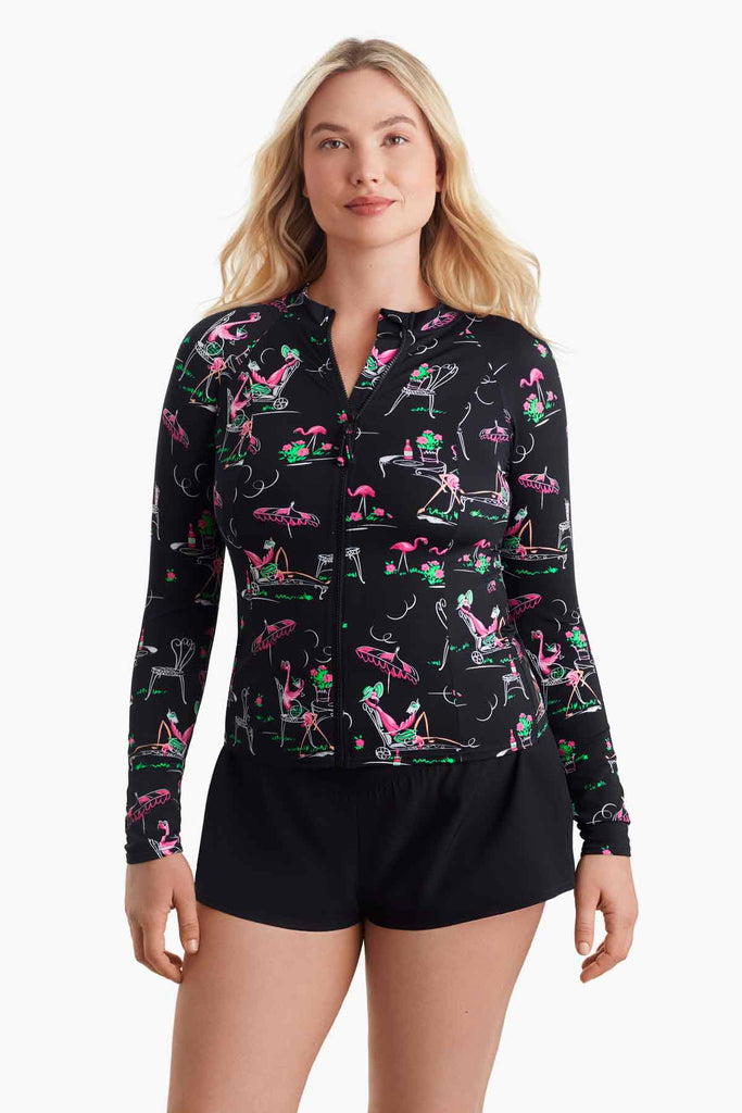 Woman wearing a flamingo printed sun shirt with a zipper in the front