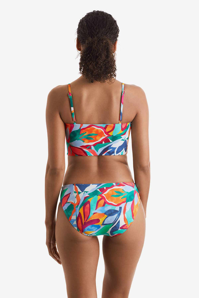 Woman faced away wearing a multicolored floral print midkini top with matching swim bottoms
