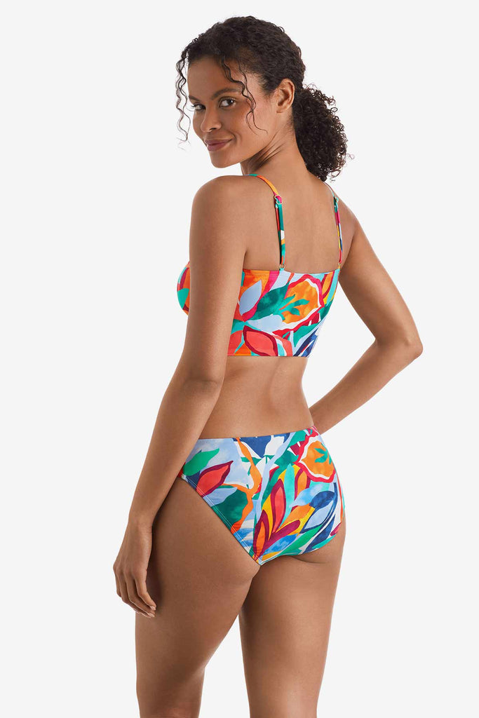 Woman faced left wearing a multicolored floral print midkini top with matching swim bottoms