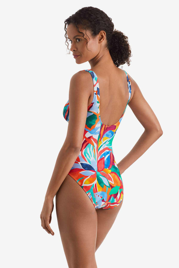 Woman turned left wearing a multicolored floral printed one-piece swimsuit