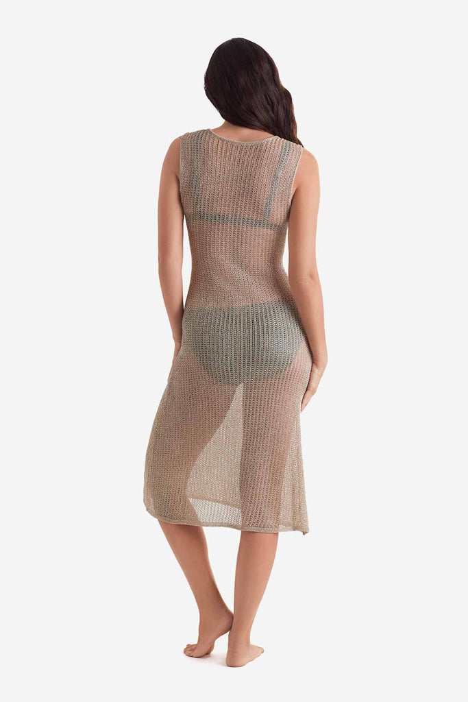 Woman turned away wearing a gold metallic knit swim dress cover up