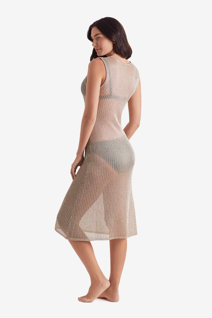 Woman turned left wearing a gold metallic knit swim dress cover up