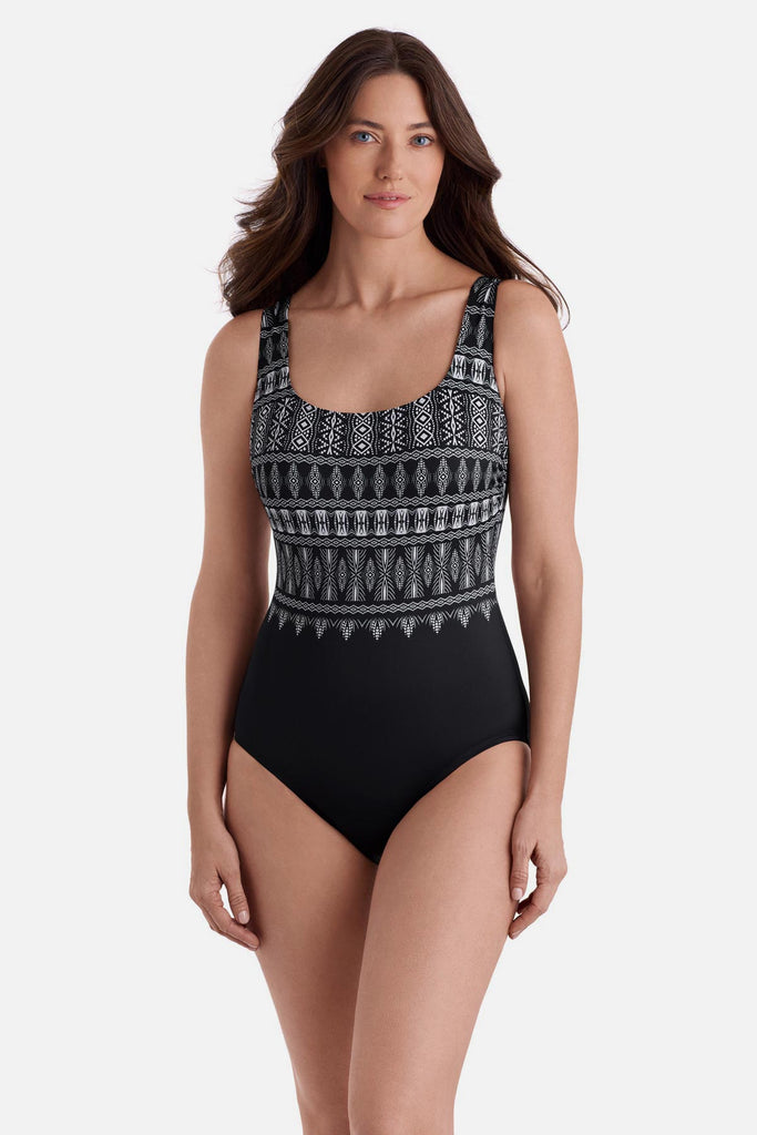 Woman wearing a black and white tribal printed one-piece swimsuit 