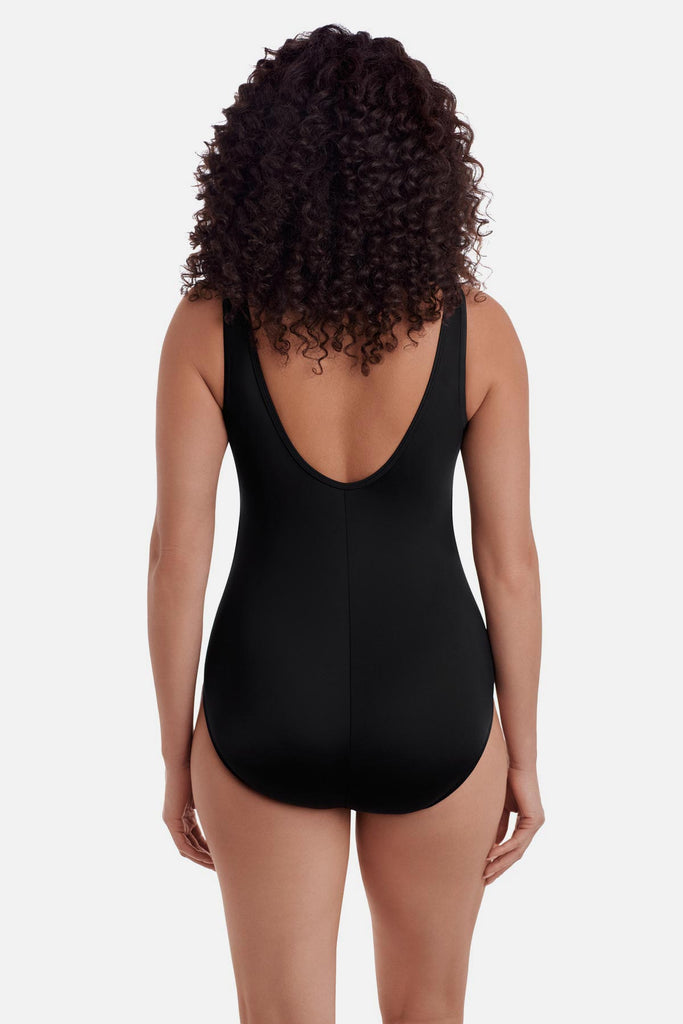 Woman turned away wearing a black one-piece swimsuit 